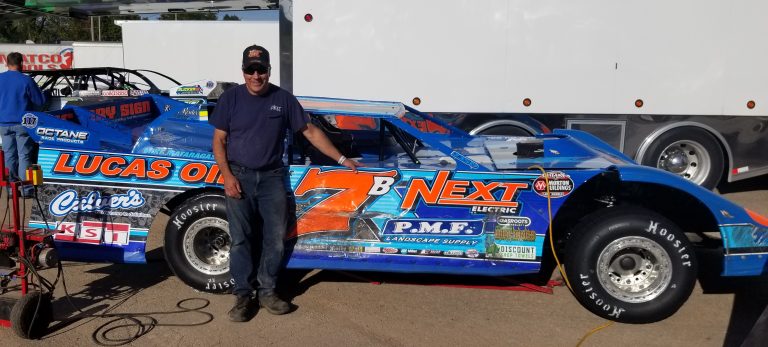 Tim Buhler standing next to his #7 dirt late model