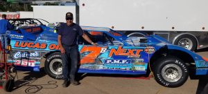 Tim Buhler standing next to his #7 dirt late model